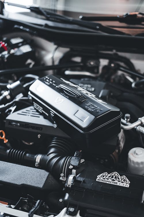 A close up of a car engine with a black box