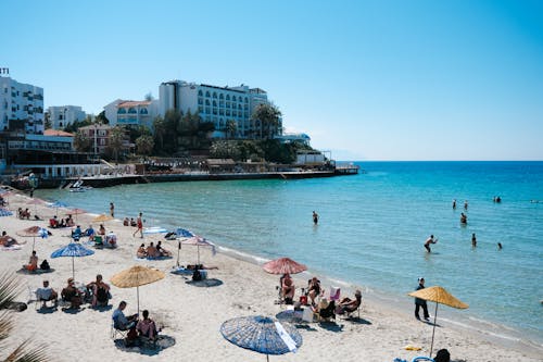 Scenic beachfront with visitors enjoying the clear blue waters