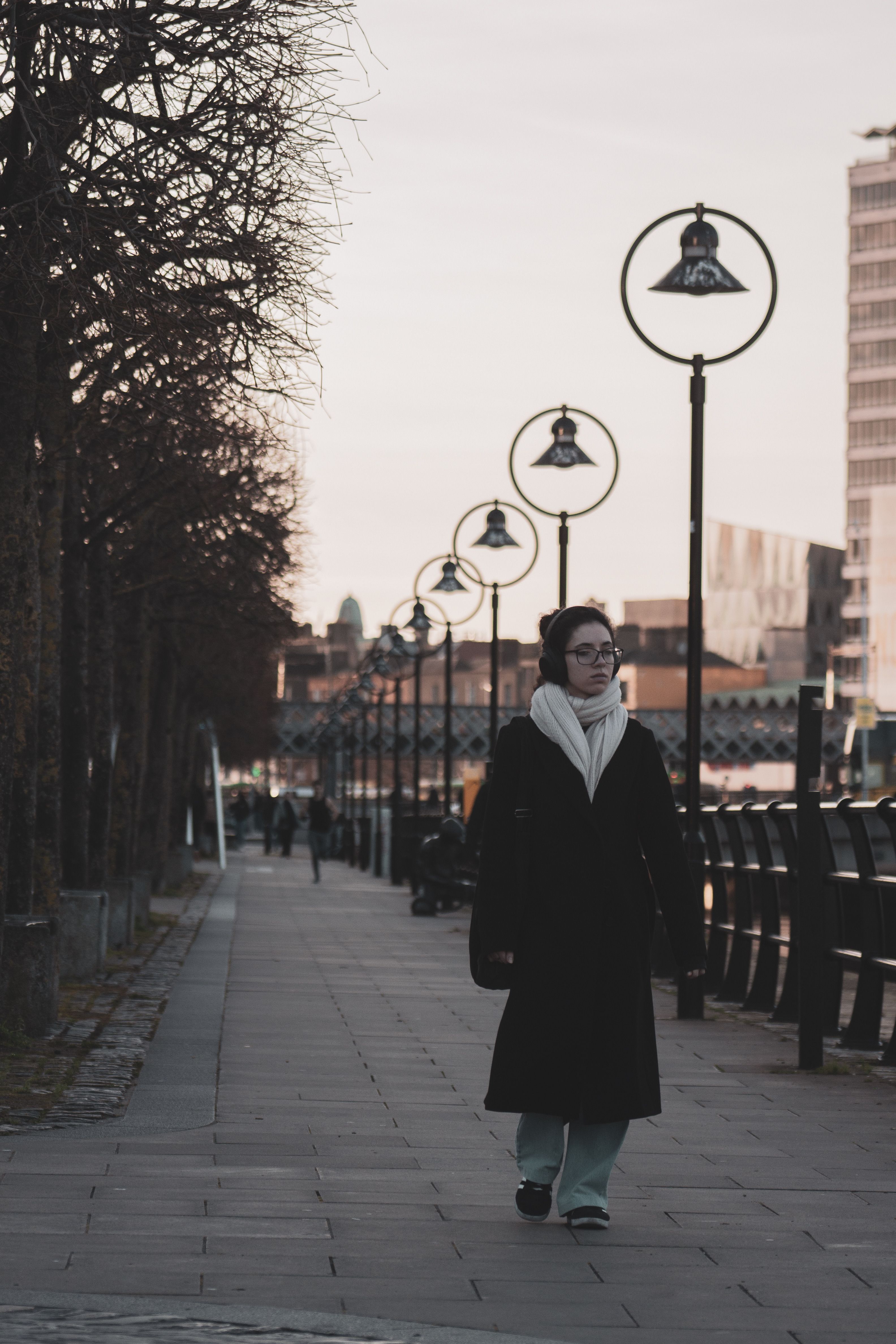 Woman in Black Coat Walking on Sidewalk · Free Stock Photo