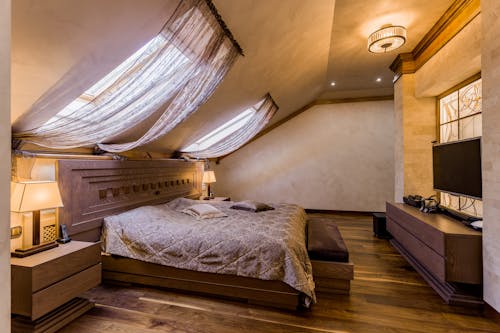 A bedroom with a bed and a skylight