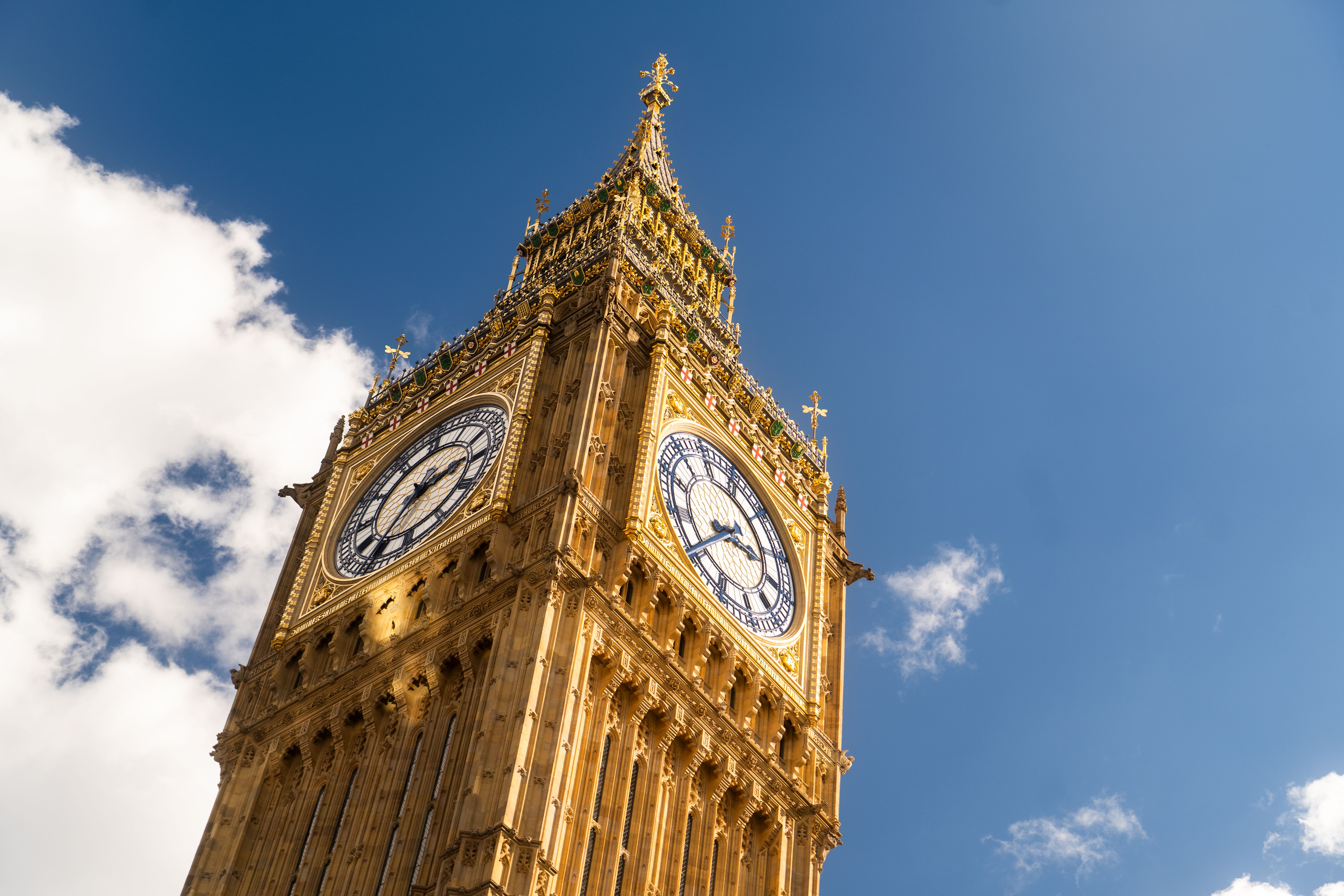 The iconic Big Ben clock tower in London against a clear blue sky.