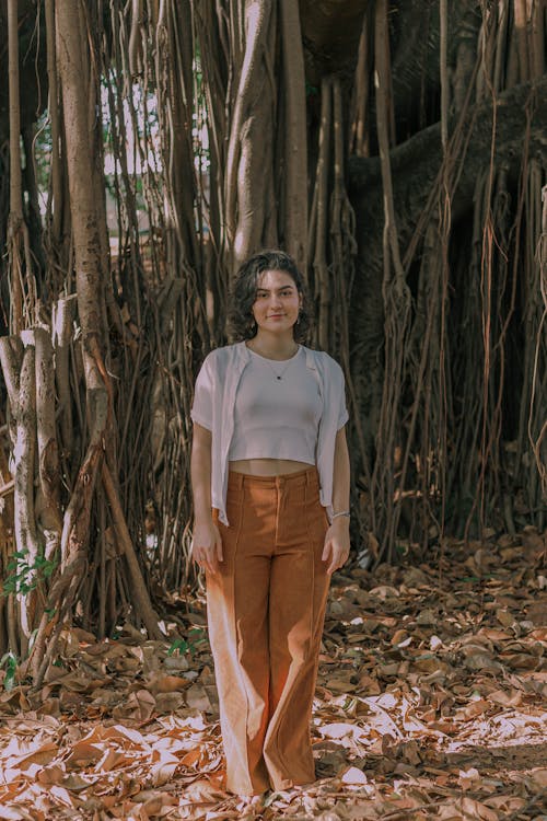 A woman standing in front of a banyan tree