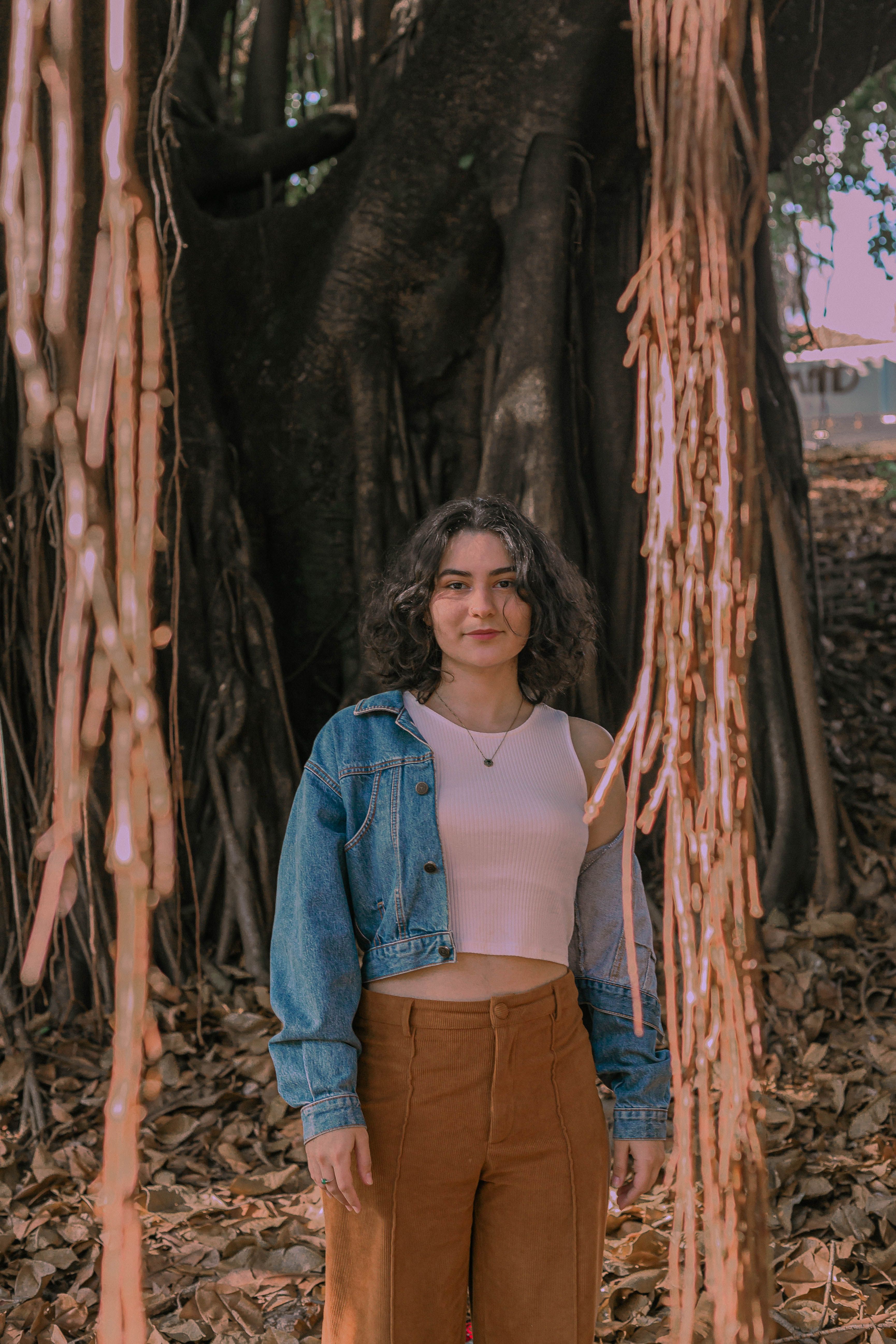 Woman in Tank Top and Jean Jacket Standing near Tree · Free Stock Photo