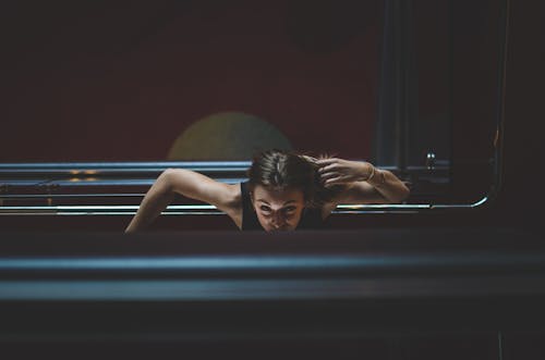 High Angle Shot of a Woman Leaning on the Railings