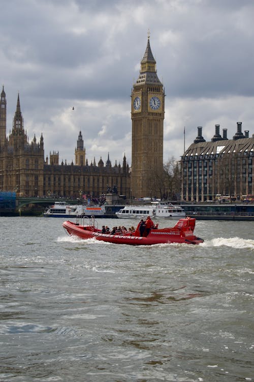 A red boat with a big ben clock in the background