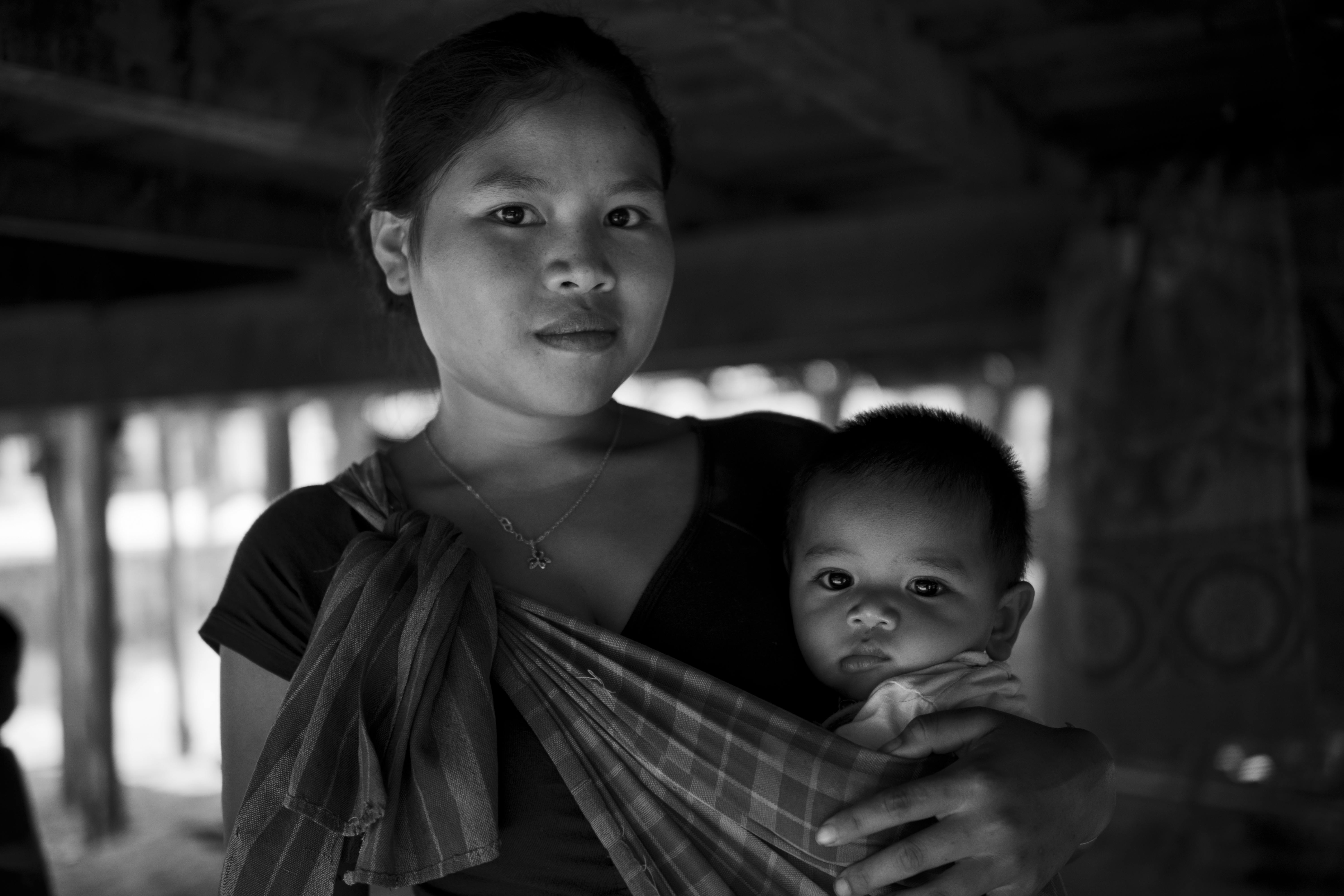 A touching black and white portrait of a mother holding her baby, exuding warmth and love.