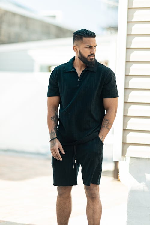 A man in black shorts and a black shirt