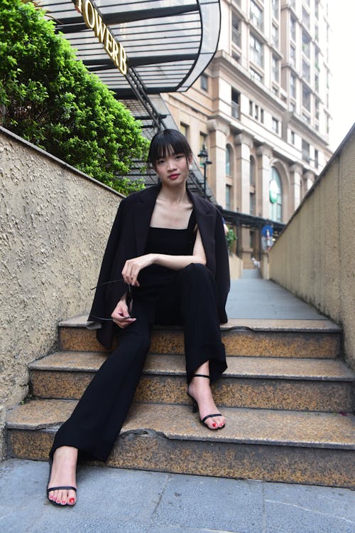 A woman sitting on the steps of a building