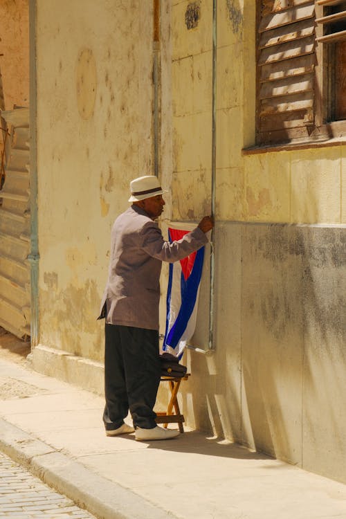 A man is painting a flag on a wall