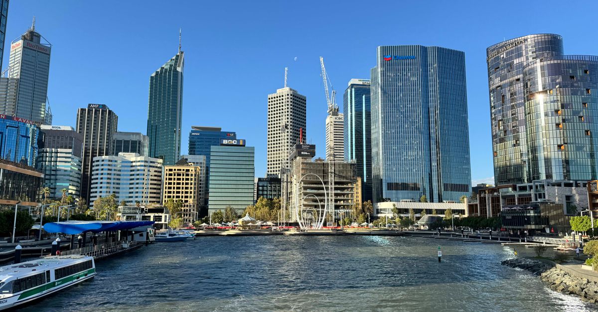 Stunning view of modern Perth skyline from the waterfront, captured on a sunny day.