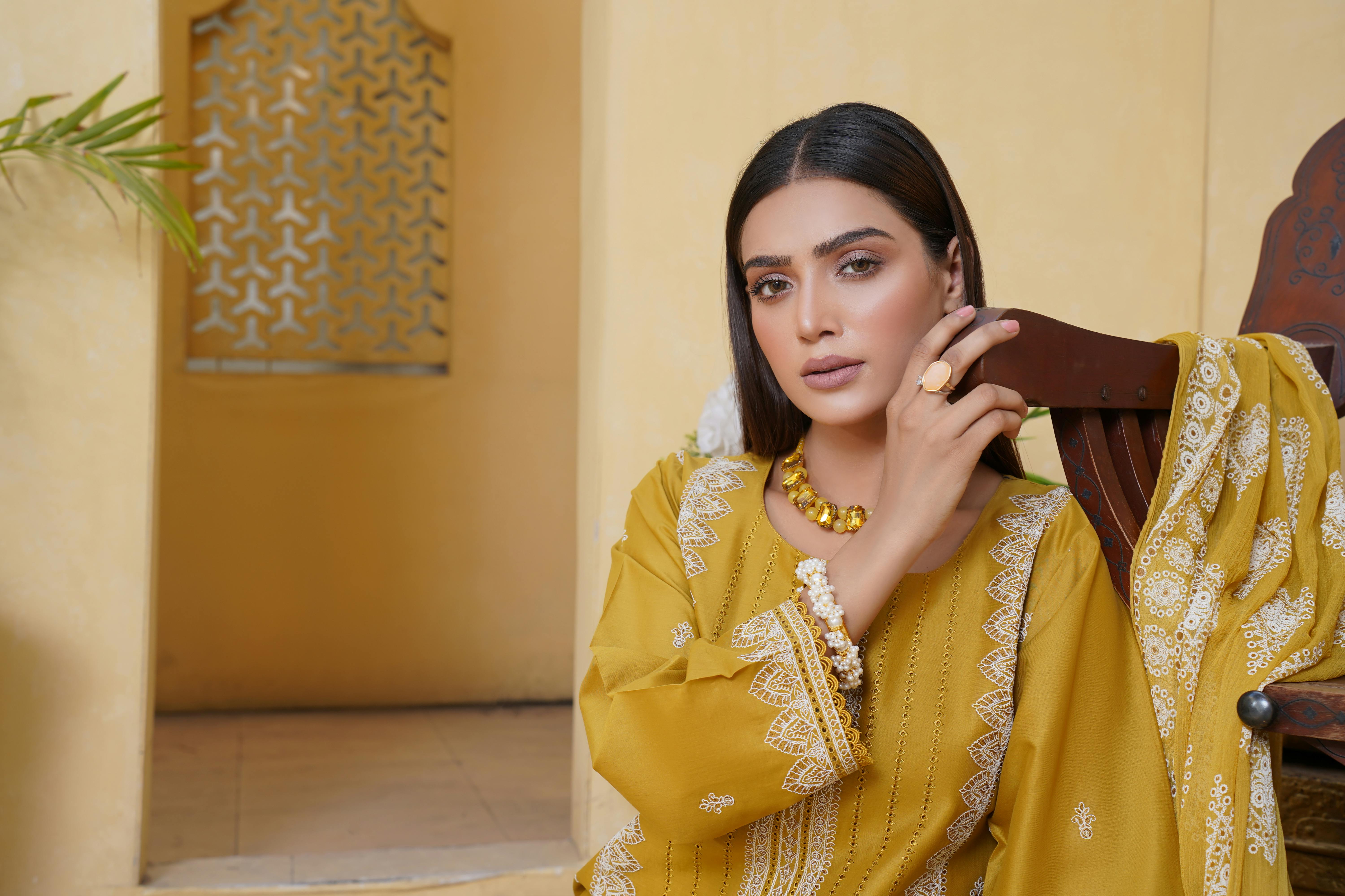 model in yellow embroidered shalwar kameez dress