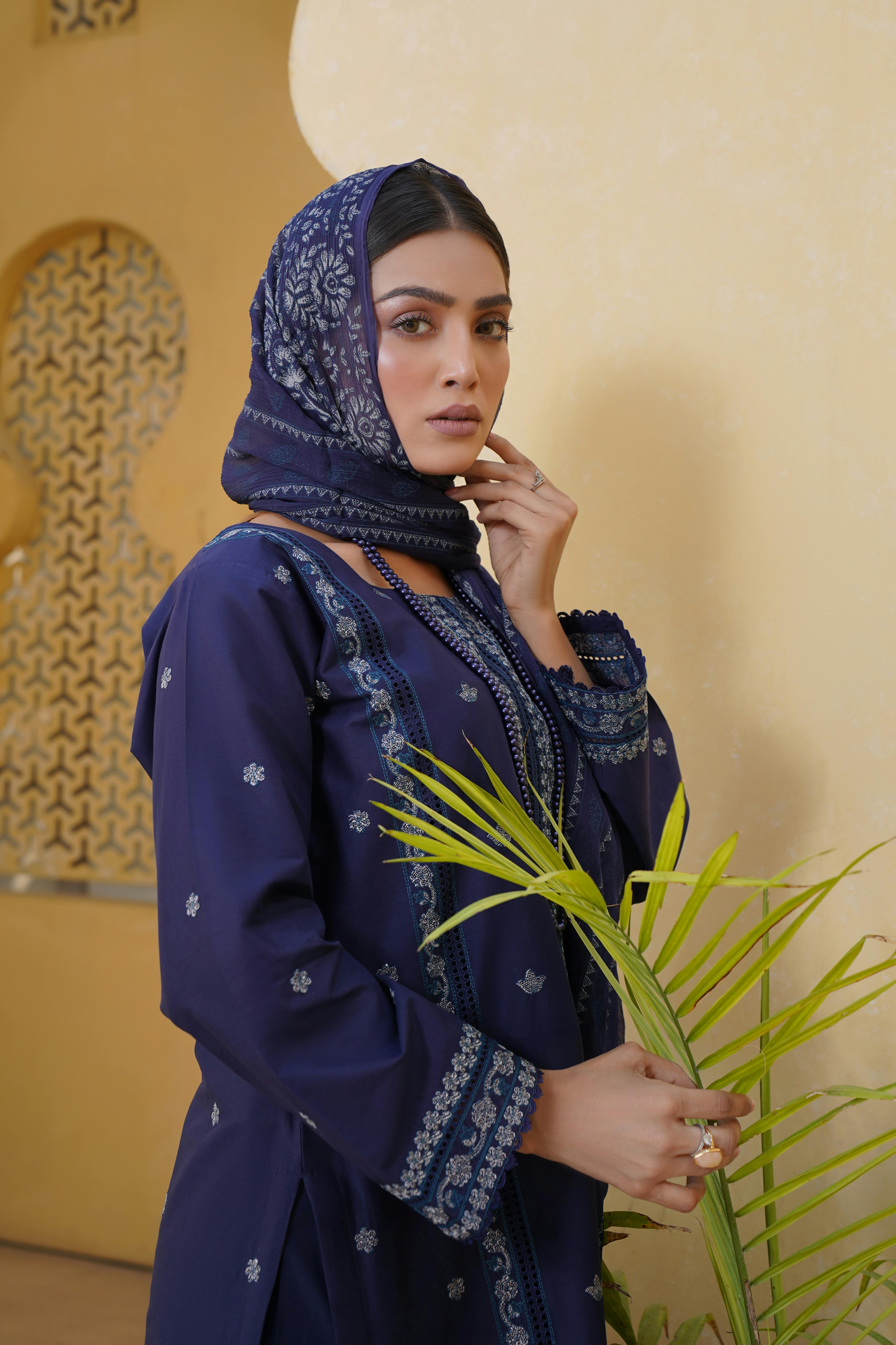model in navy blue embroidered dress and headscarf
