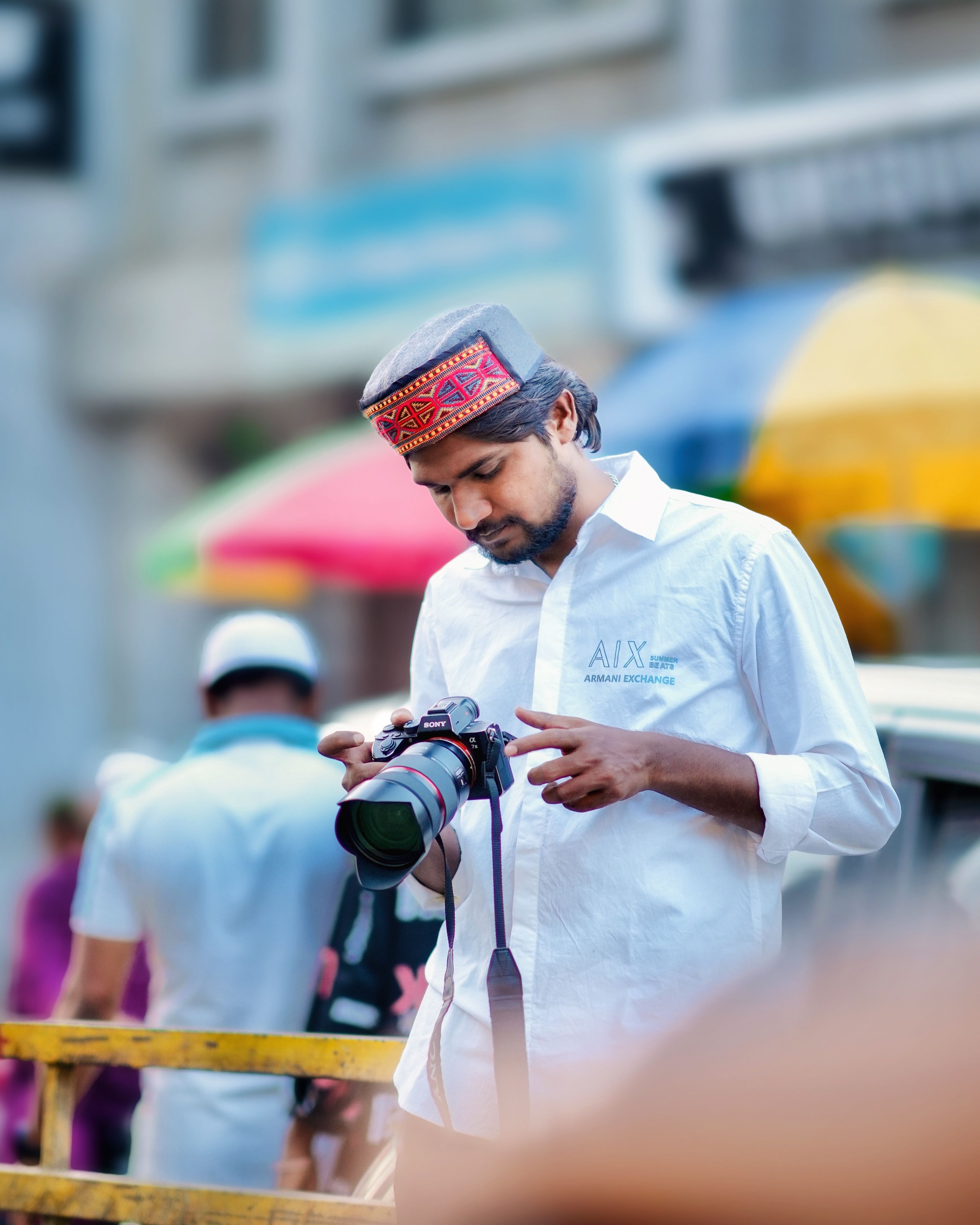 A street photographer capturing moments in a vibrant market setting in Aurangabad, India.