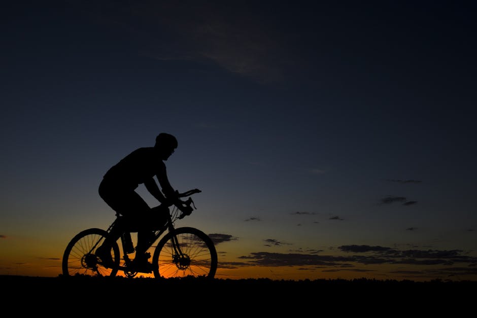 Man Riding Bicycle during Nightfall