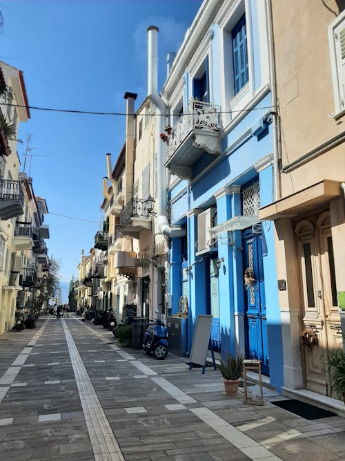 A street with blue and white buildings and a bike