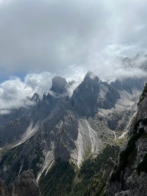 Free Breathtaking aerial view of the rugged Dolomites in Auronzo di Cadore, shrouded in clouds. Stock Photo