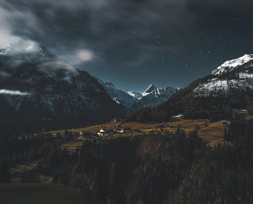 A night scene with mountains and clouds