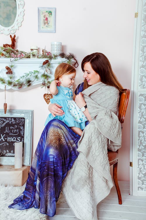 Gratuit Femme En Robe Bleu Blanc Et Marron Tenant Bébé En Robe Turquoise à L'intérieur De La Maison Photos