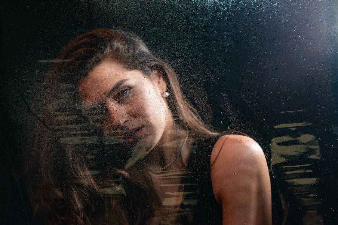 Portrait of Woman behind Window Glass at Night · Free Stock Photo