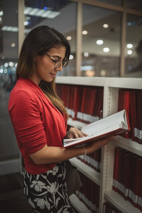 Woman Reading a Book While Standing