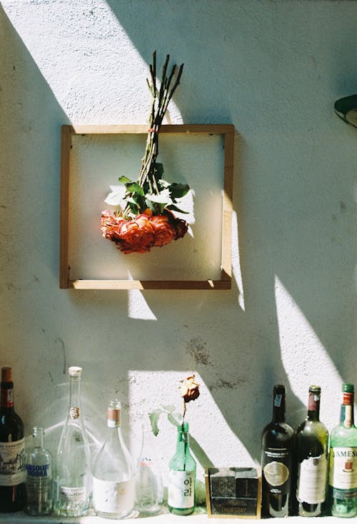 A framed flower arrangement on a wall