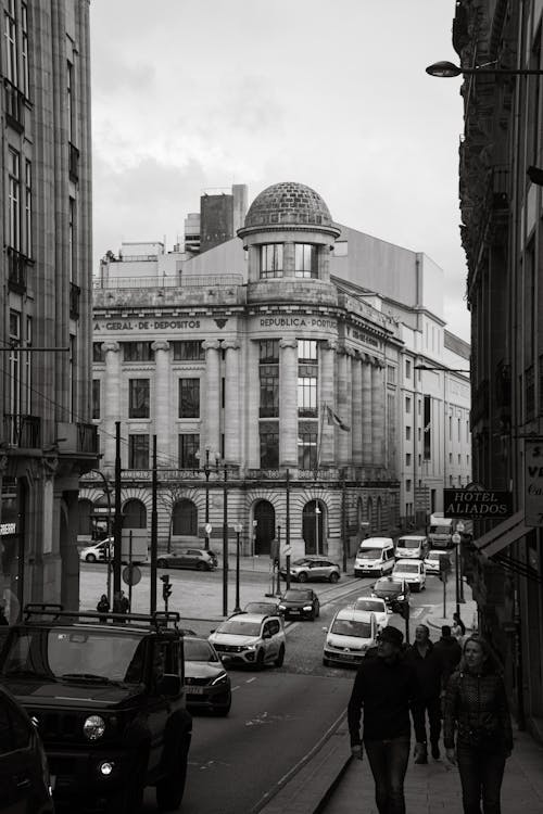 Black and white photo of people walking down a street