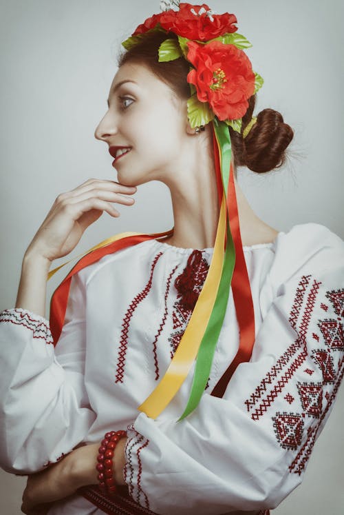 Woman in White Long-sleeved Top Touching Her Chin