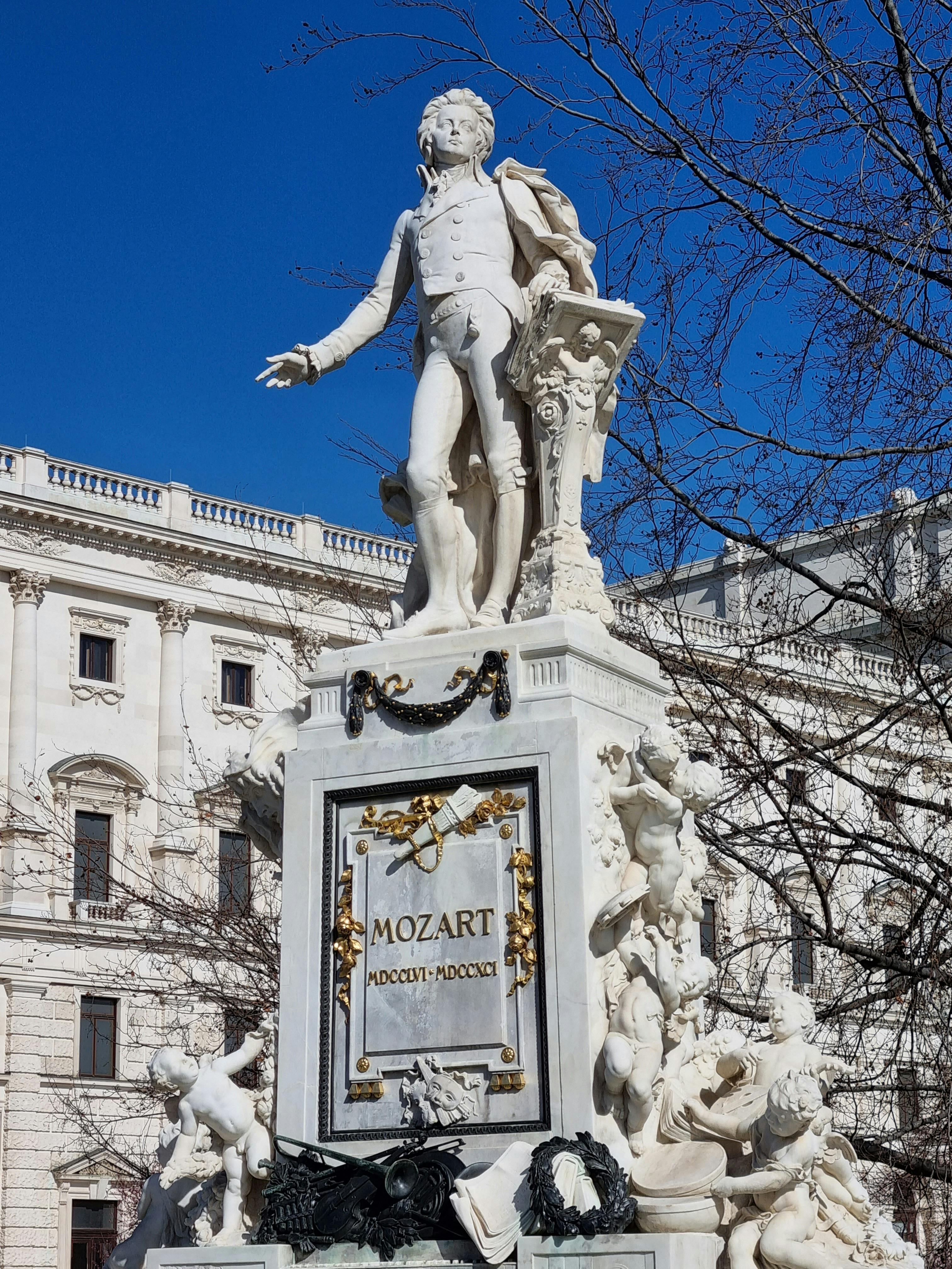 Stunning view of the Mozart Monument in Vienna, Austria, with clear blue skies.