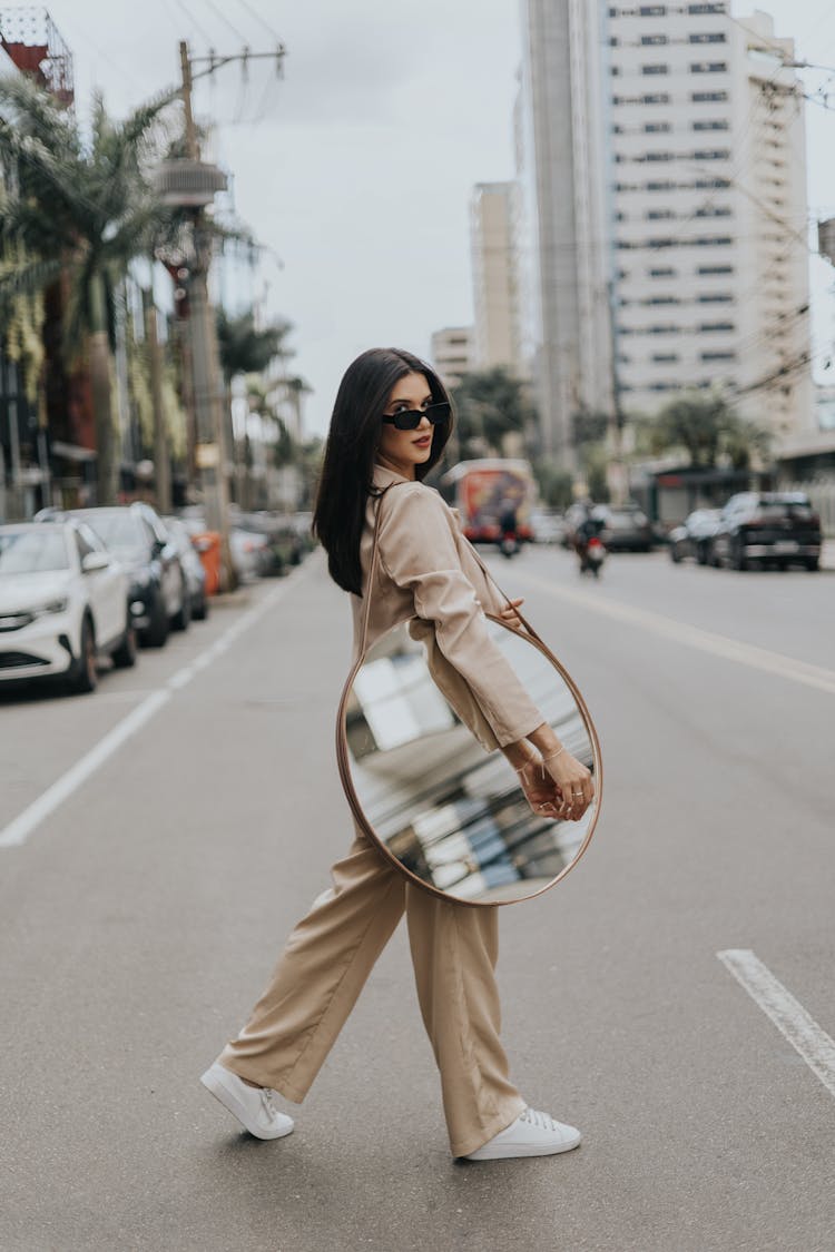 Woman Holding Mirror On Street