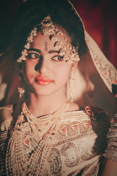 Portrait of a bride adorned in traditional jewelry and attire, exuding elegance and cultural richness.