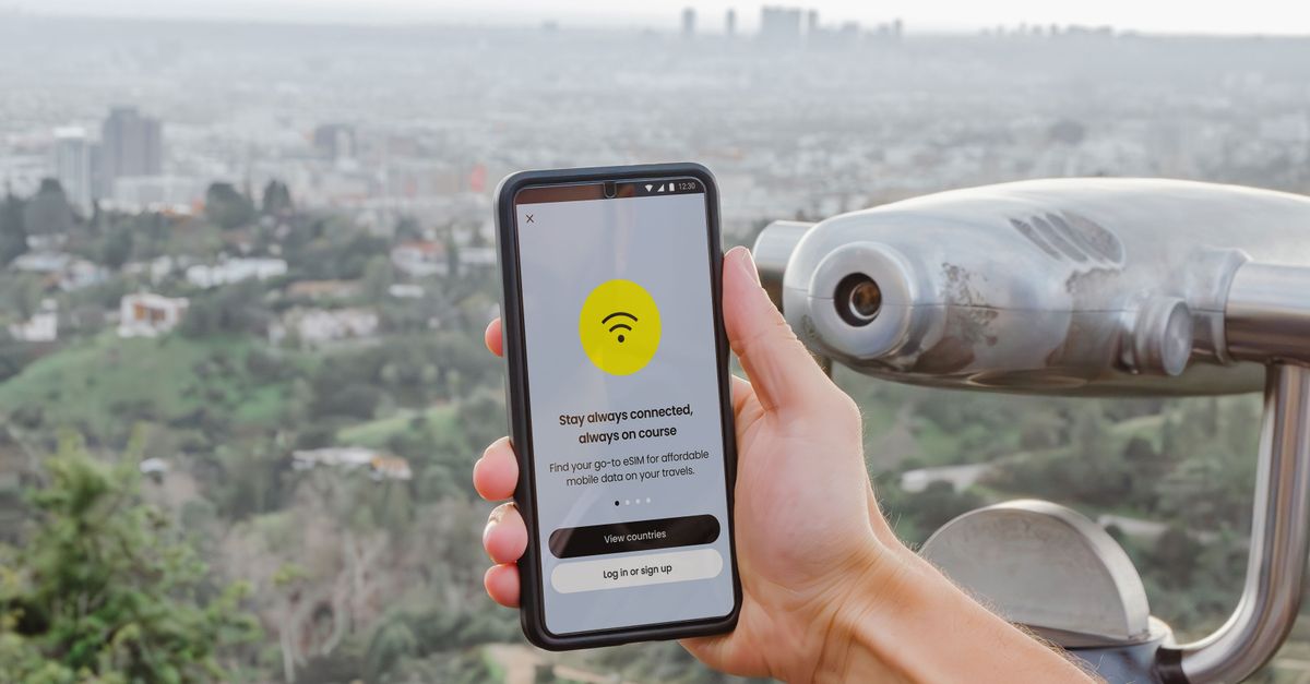 Hispanic man comparing car insurance quotes on smartphone in los angeles