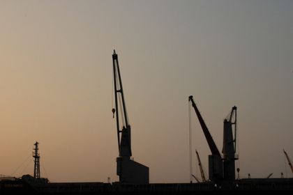 Harbour cranes at sunset, photo by Ana Morales on Pexels