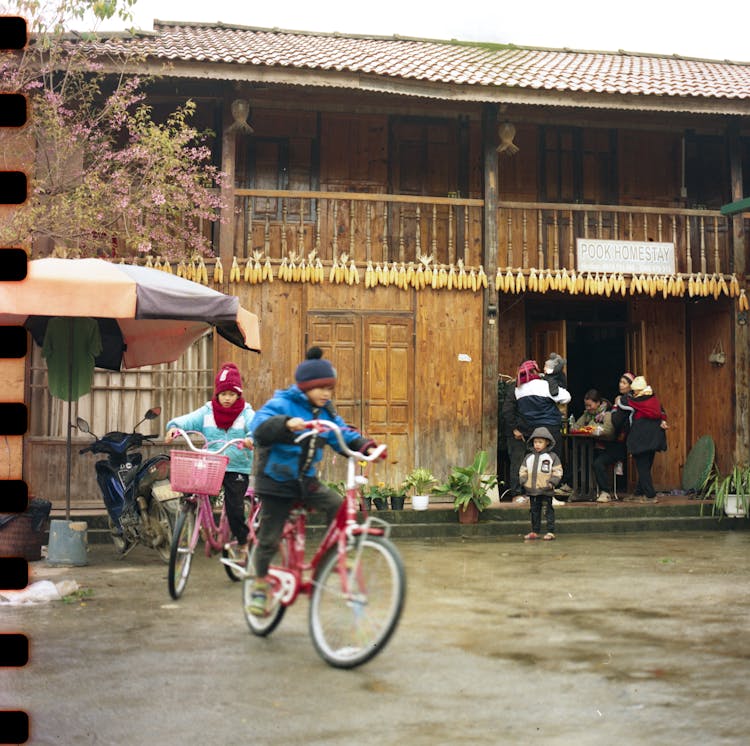 A Group Of People Riding Bikes And A Man Walking