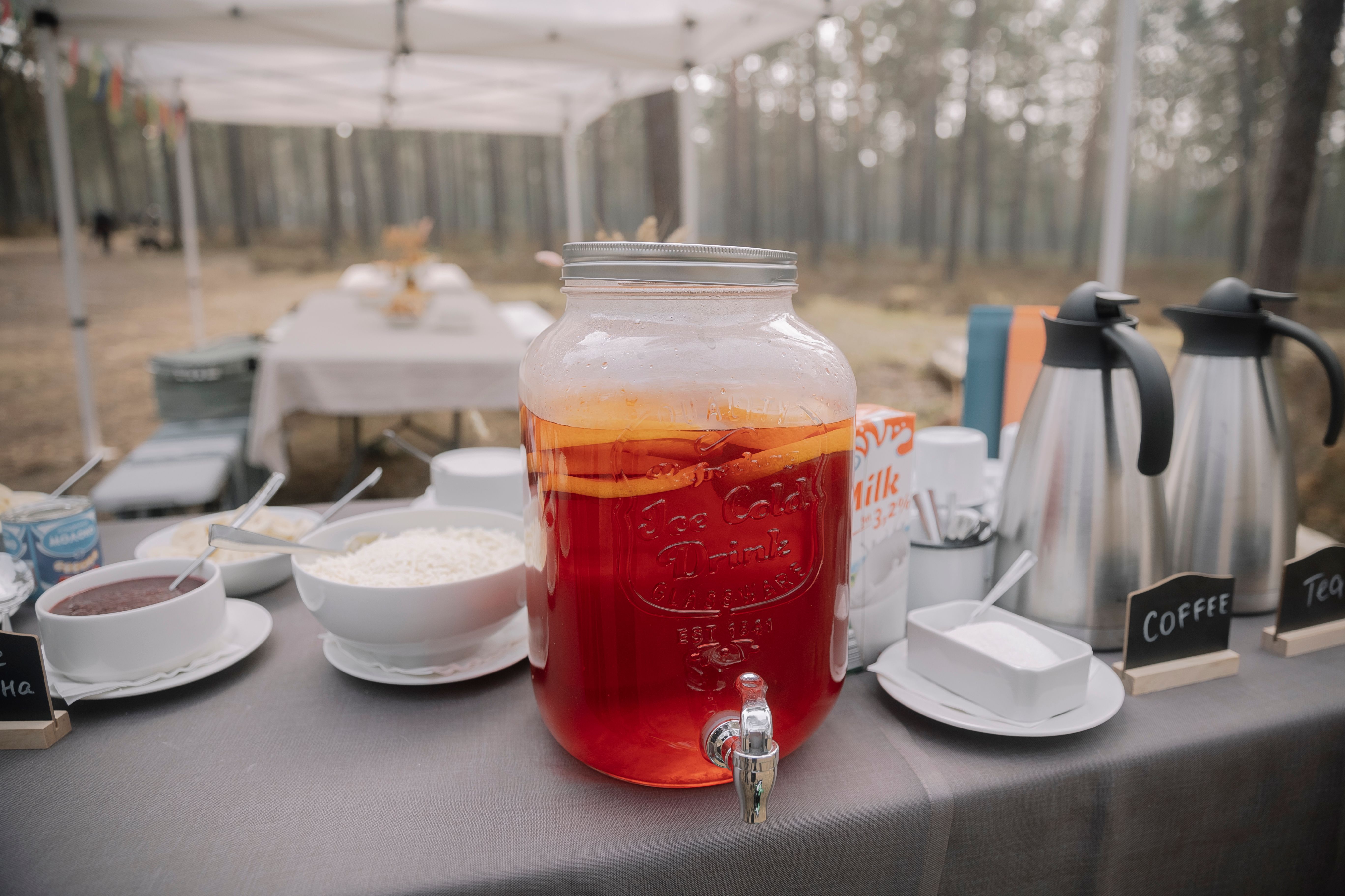 A table with a pitcher of tea and coffee