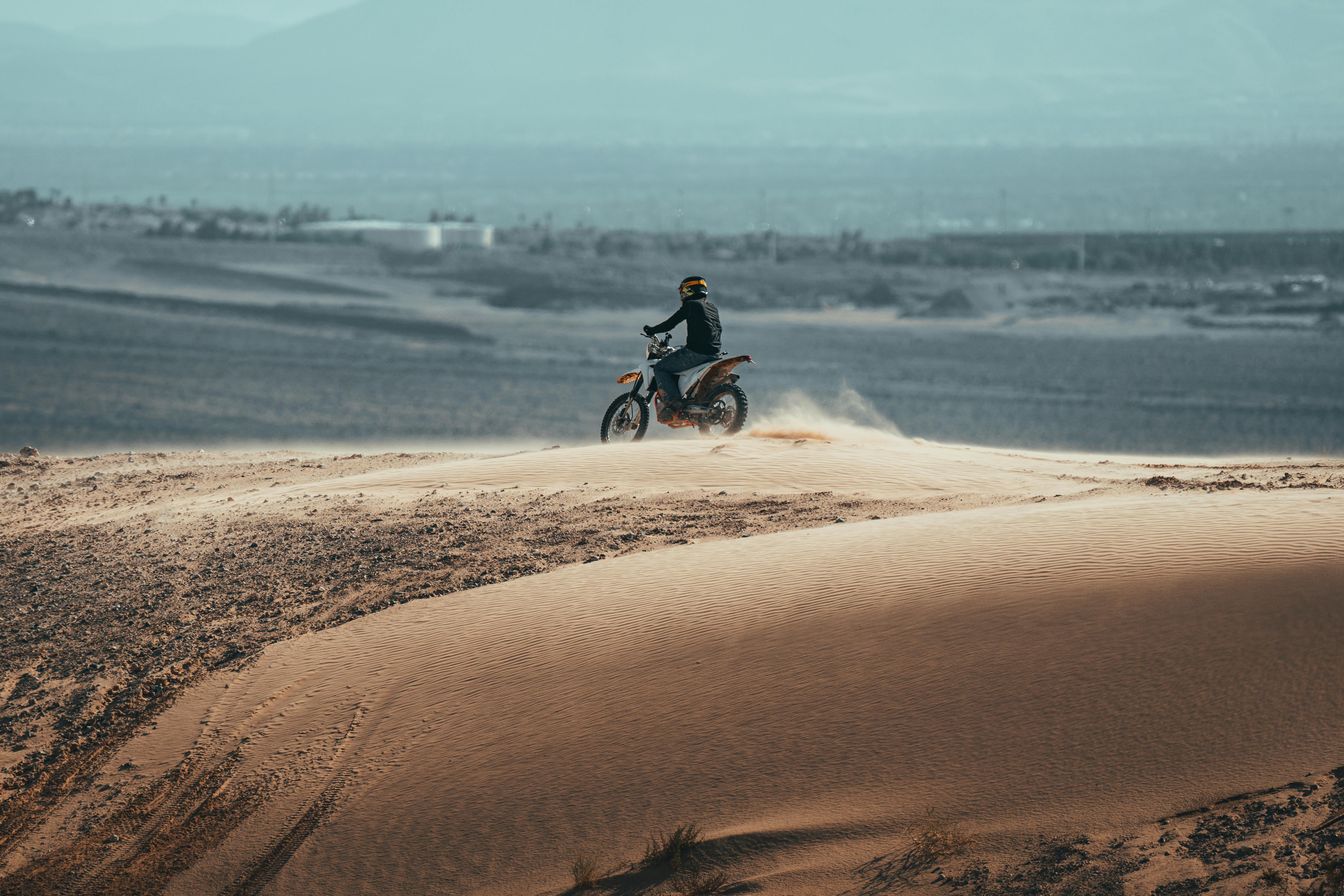 A motorcyclist enjoys a thrilling ride on the sandy dunes near Las Vegas.