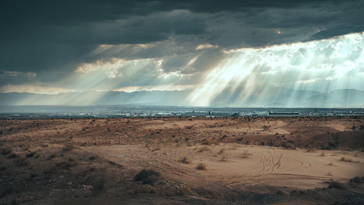 Storm Cloud and Sunbeams over Beach on Sea Coast · Free Stock Photo