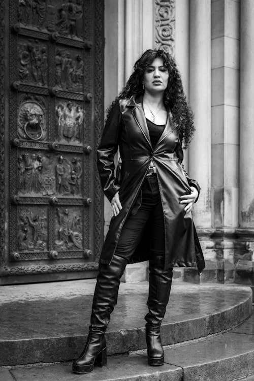 Black and White Photo of a Model Posing in a Leather Coat 