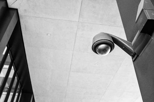 A black and white photo of a security camera