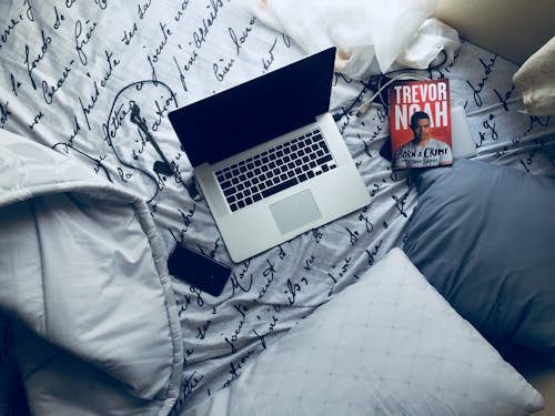 Free laptop on bed
 Stock Photo