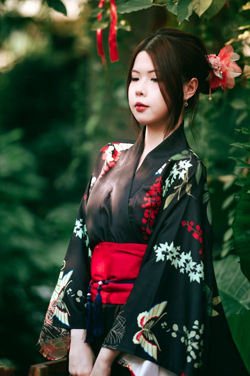 A woman in a kimono standing in a garden