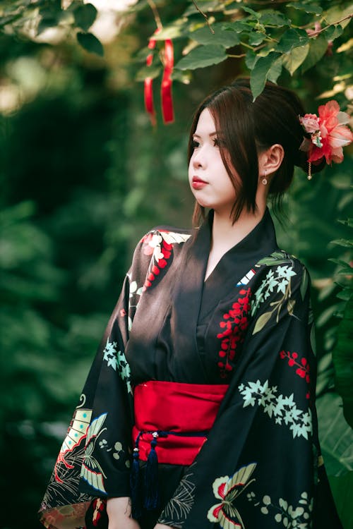 A woman in a kimono standing in the garden