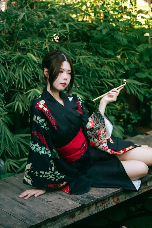 A woman in a kimono sitting on a bench