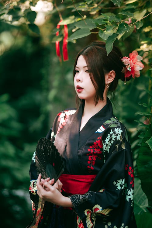 A woman in a kimono standing in the garden