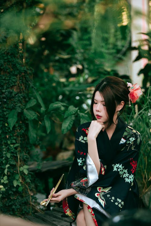 A woman in a kimono sitting on a bench