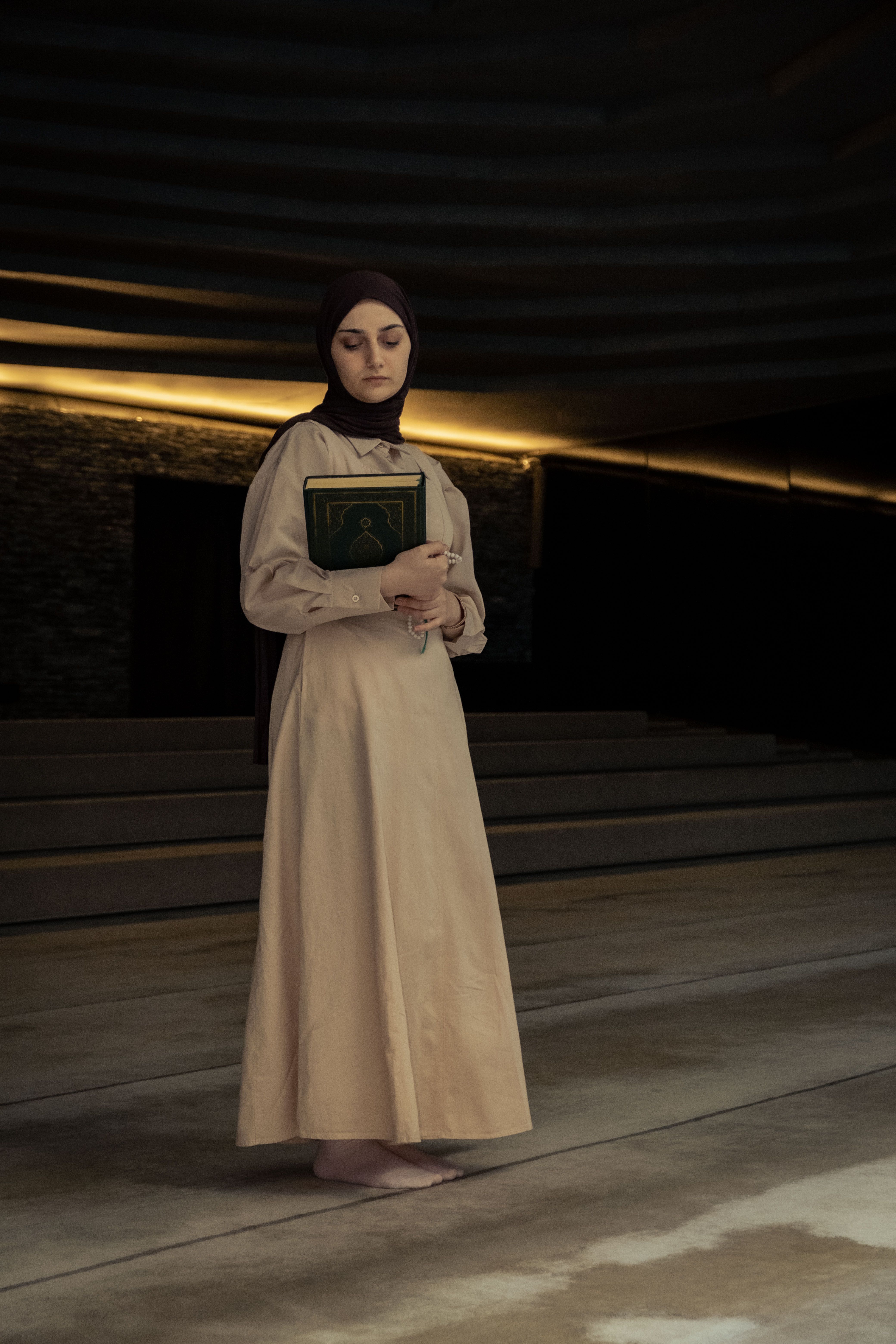 Young Woman Wearing a Hijab Standing in a Mosque with a Book in Hand ...