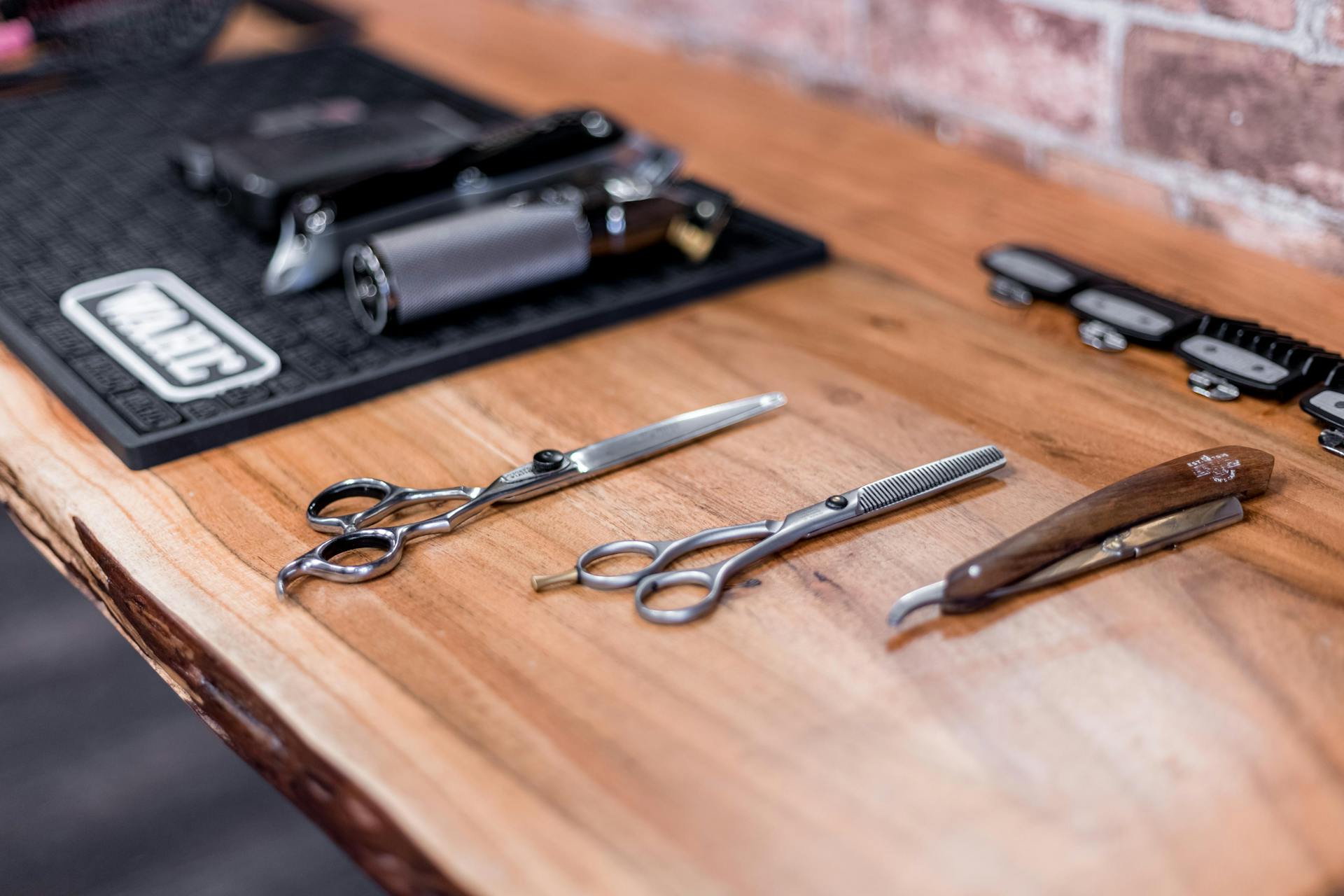 Scissors and a Razor Lying on a Wooden Shelf