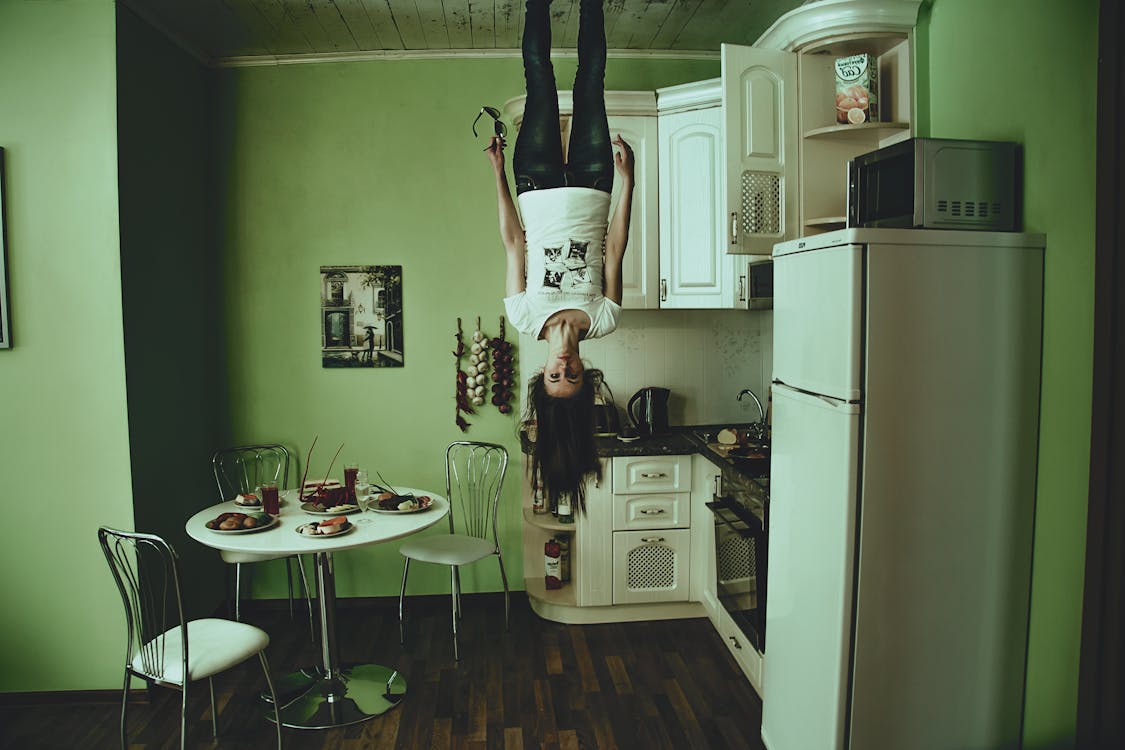 Free Woman Standing on Ceiling Inside Room Stock Photo