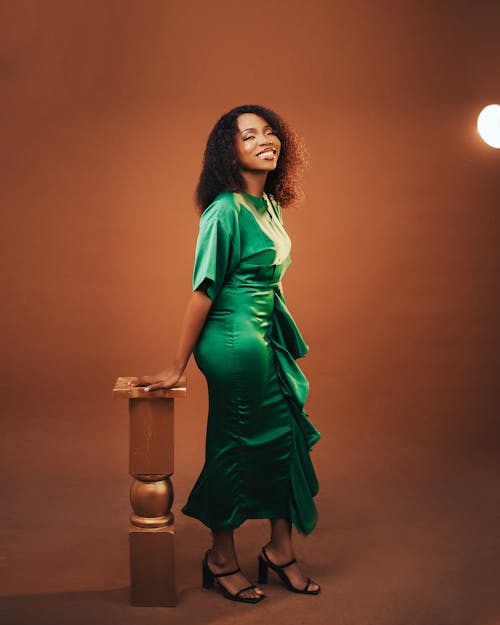 A woman in a green dress posing for the camera