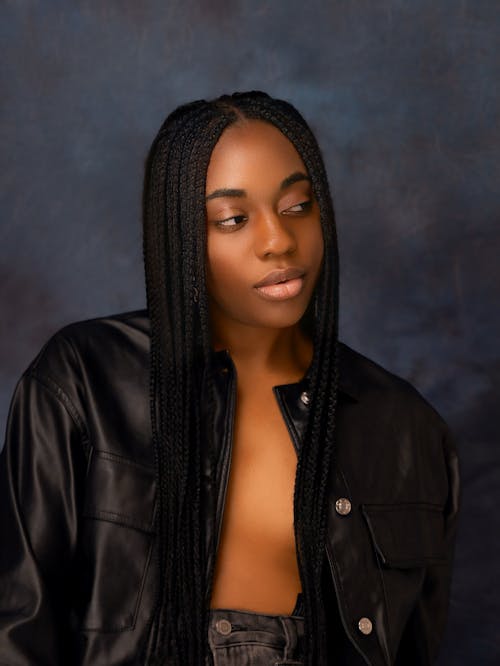 A woman with long braids posing for a photo