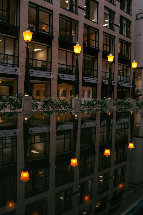 A reflection of a building in a puddle of water